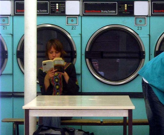 No one cares about your dirty laundry. Not this chick. She's reading a book. (SOURCE: Gideon's Flickr photostream)